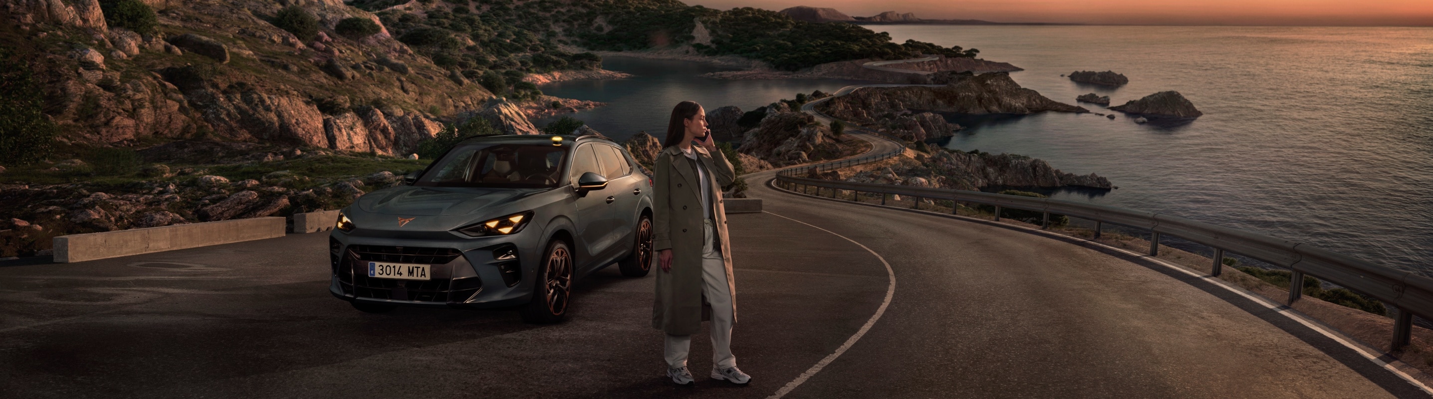 CUPRA Terramar parcheggiata su una strada vista mare al tramonto, SUV sportivo dal design distintivo e anima performance.