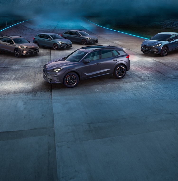 A person intently looking at their smartphone, standing outdoors with blurred modern city buildings and a bright sunset sky in the background.